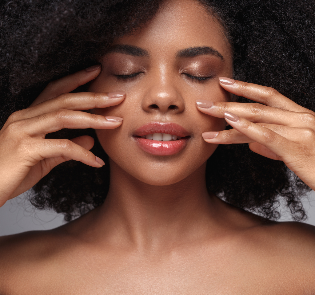 woman with glowing skin in soft natural light representing nervous system wellness and healthy aging