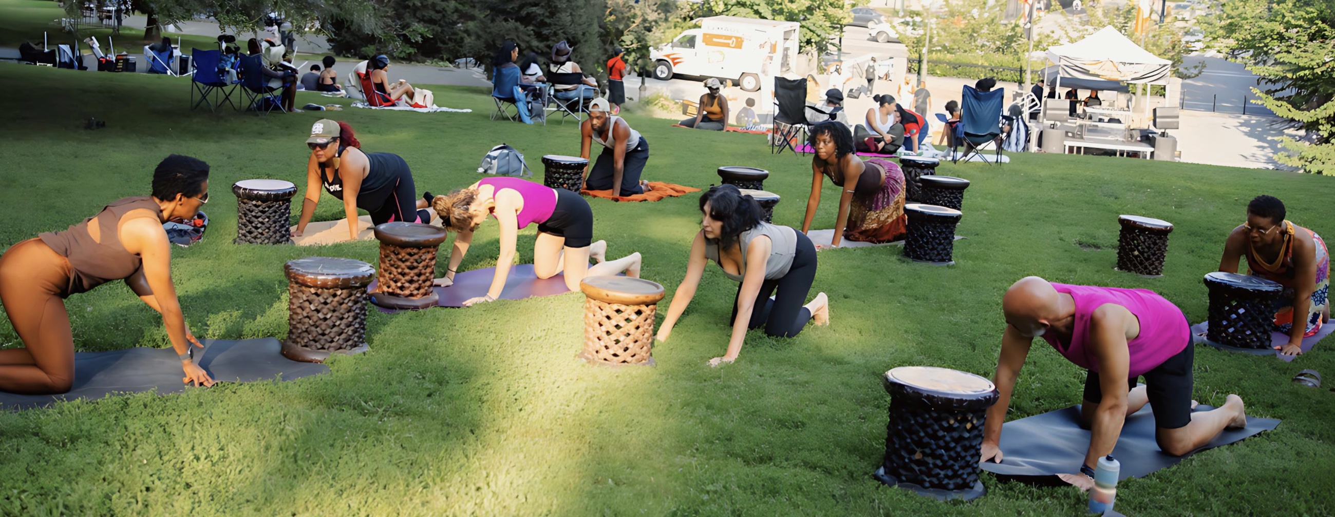Michelle leading an outdoor Movement Rituals yoga class with people practicing beside the Roks